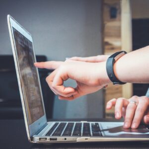 fingers pointing at a computer screen